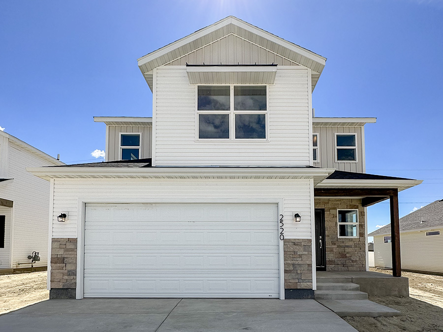 Charming 2 story home neutral stone accent  with white and black exterior finishes